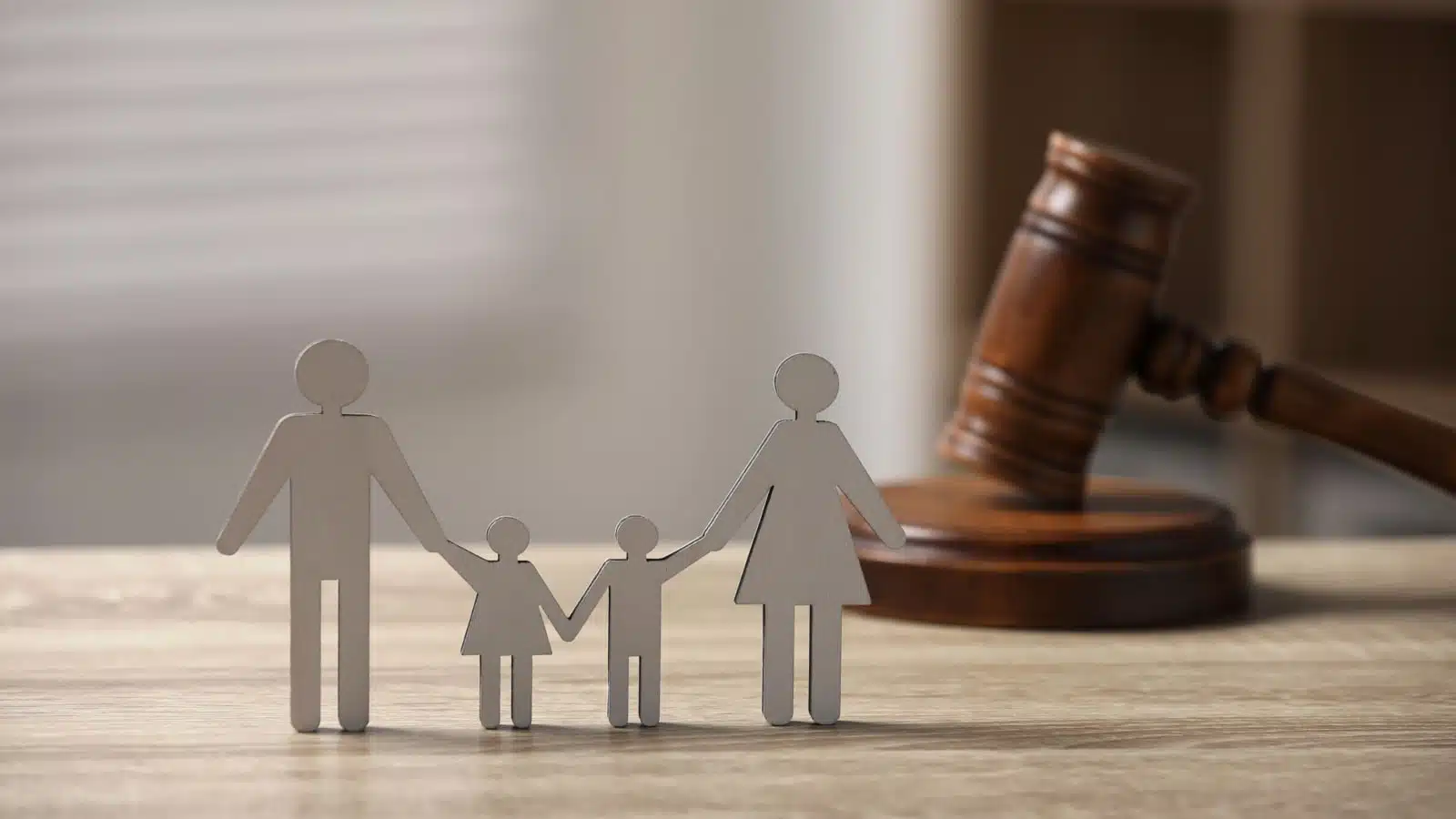 How to Win a Child Support Modification Case Paper cutout family of a parent and two children beside a judge's gavel, representing a Missouri child support modification case