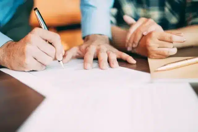 A couple reviewing a document with an attorney